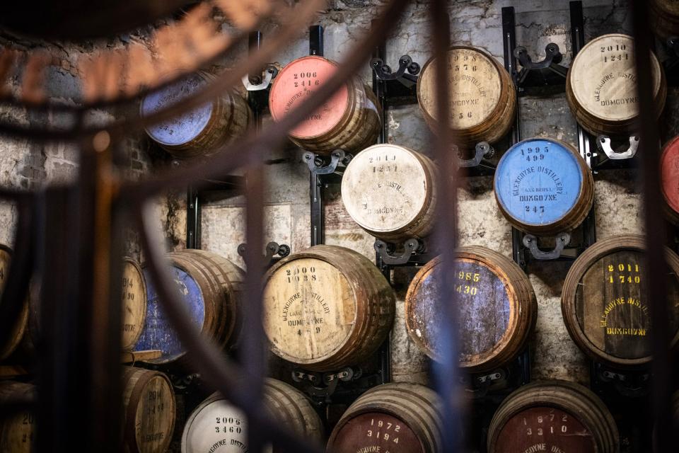 Casks behind a black metal gate